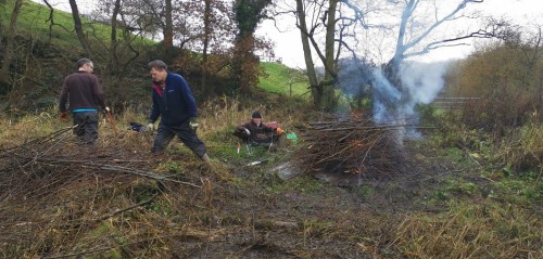 Volunteers getting bonfire started